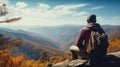 Man relaxing on autumn hiking trip. Man hiker standing on top of the mountain enjoying beautiful fall scenery. Smoky Mountains