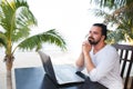 Man relaxing on the beach with laptop, freelancer workplace, dream job Royalty Free Stock Photo