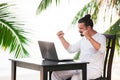 Man relaxing on the beach with laptop, freelancer workplace, dream job Royalty Free Stock Photo