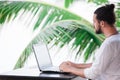 Man relaxing on the beach with laptop, freelancer workplace, dream job Royalty Free Stock Photo