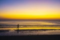 Man relaxing on the beach at sunrise, beautiful cloudy sky