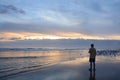 Man relaxing on the beach at sunrise. Royalty Free Stock Photo