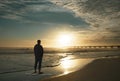 Man relaxing on the beach at sunrise. Royalty Free Stock Photo