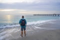 Man relaxing on the beautiful beach at sunrise. Royalty Free Stock Photo