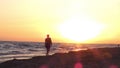 Man relaxing on the beautiful beach at sunrise. Sun reflected on beach, Royalty Free Stock Photo