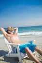 Man relaxing on deck chair at the beach Royalty Free Stock Photo