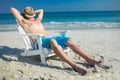 Man relaxing on deck chair at the beach Royalty Free Stock Photo