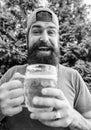 Man relaxing enjoying beer hot summer day. Beer and ale concept. Quench thirst. Hipster brutal bearded man hold mug cold
