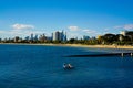 Man relaxing on floaty with Melbourne cityscape in background