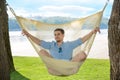 Man relaxing in hammock