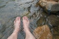 Man Relaxing His Feet in the Cold and Fresh Waterfall Royalty Free Stock Photo