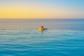 Man relaxing In Infinity Edge Swimming Pool Water Royalty Free Stock Photo