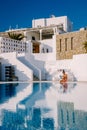 man relaxing in infinity swimming pool looking at the ocean,young man in the swimming pool relaxing reading a book by Royalty Free Stock Photo