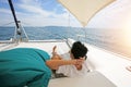 Man relaxing lie down on Sailboat Deck spending summer day outside Royalty Free Stock Photo