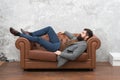 Man relaxing on luxurious leather couch, feeling comfortable concept