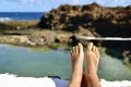 Man relaxing in a natural pool of seawater Royalty Free Stock Photo