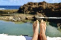 Man relaxing in a natural pool of seawater