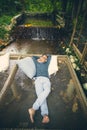 Man relaxing on net cradle over flowing creek ,vacation traveling in tropical rain forest Royalty Free Stock Photo