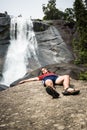 Man relaxing next to waterfall Royalty Free Stock Photo