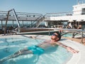 Man relaxing in the pool on the deck Royalty Free Stock Photo