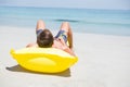 Man relaxing on pool raft at beach Royalty Free Stock Photo