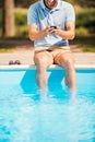 Man relaxing poolside. Royalty Free Stock Photo