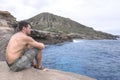 Man relaxing by the sea in Oahu, Hawaii Royalty Free Stock Photo