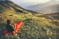 Man relaxing in sleeping bag enjoying sunset mountains Royalty Free Stock Photo