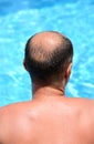 Man relaxing at the swimming pool, back Royalty Free Stock Photo