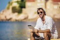 Man using digital tablet at sea beach Royalty Free Stock Photo