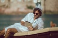 Man relaxing and use digital tablet at sea beach Royalty Free Stock Photo