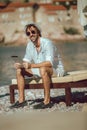 Man relaxing and use digital tablet at sea beach Royalty Free Stock Photo