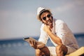 Man relaxing and use tablet computer at the beach Royalty Free Stock Photo