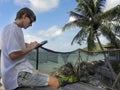 Man relaxing and use tablet computer at sea beach Royalty Free Stock Photo