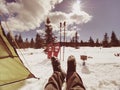 Man relaxing. Winter view from camping tent entrance out