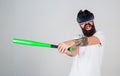 Man reliving stress in virtual reality game, emotion control concept. Angry bearded man using baseball bat for fighting