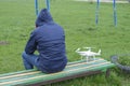 A man with a remote control quadroopter in his hands is sitting Royalty Free Stock Photo