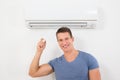 Man With Remote Control To Operate Air Conditioner Royalty Free Stock Photo