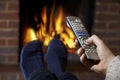 Man With Remote Control Watching Television And Relaxing By Fire Royalty Free Stock Photo