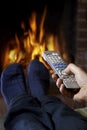 Man With Remote Control Watching Television And Relaxing By Fire Royalty Free Stock Photo