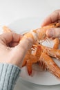 man removes the head of a cooked prawn Royalty Free Stock Photo