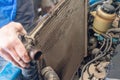 A man removes an old broken radiator from a car Royalty Free Stock Photo