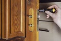A man removes the old door lock