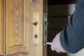 A man removes the old door lock