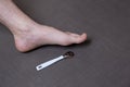 Man removing corn, callus from his feet using a razor file, masculine skin care, skin disease, fungal infection, skin