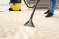 Man removing dirt from carpet with vacuum cleaner in roo Royalty Free Stock Photo