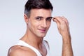 Man removing eyebrow hairs with tweezing Royalty Free Stock Photo