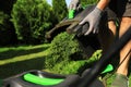 Man removing grass out of lawn mower box in garden, closeup Royalty Free Stock Photo