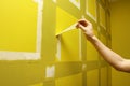 man removing masking tape from wall Royalty Free Stock Photo