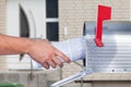 Man removing a newspaper from his mailbox Royalty Free Stock Photo